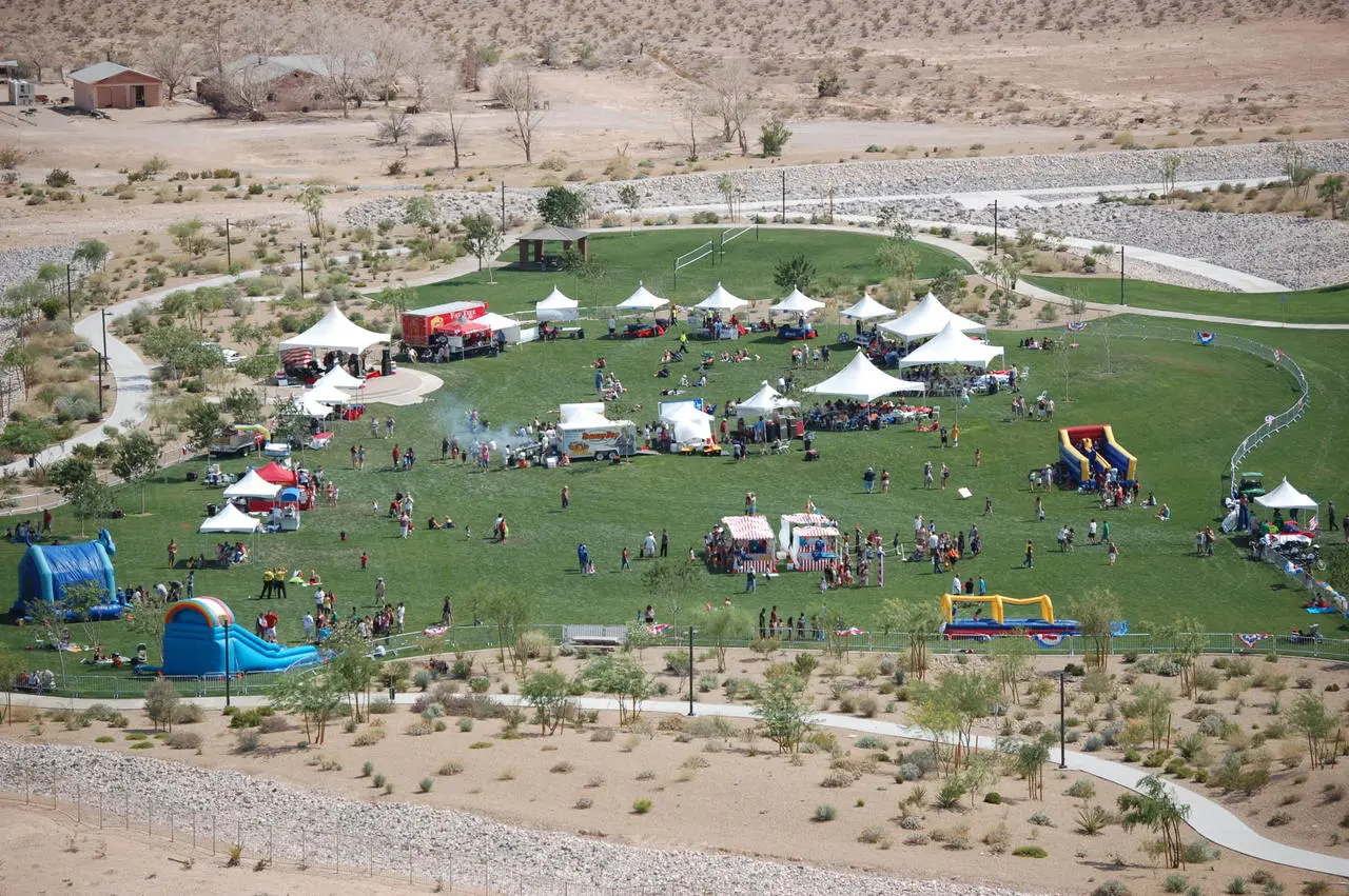 Aerial view of outdoor community fair with tents, inflatables, and food trucks in Las Vegas